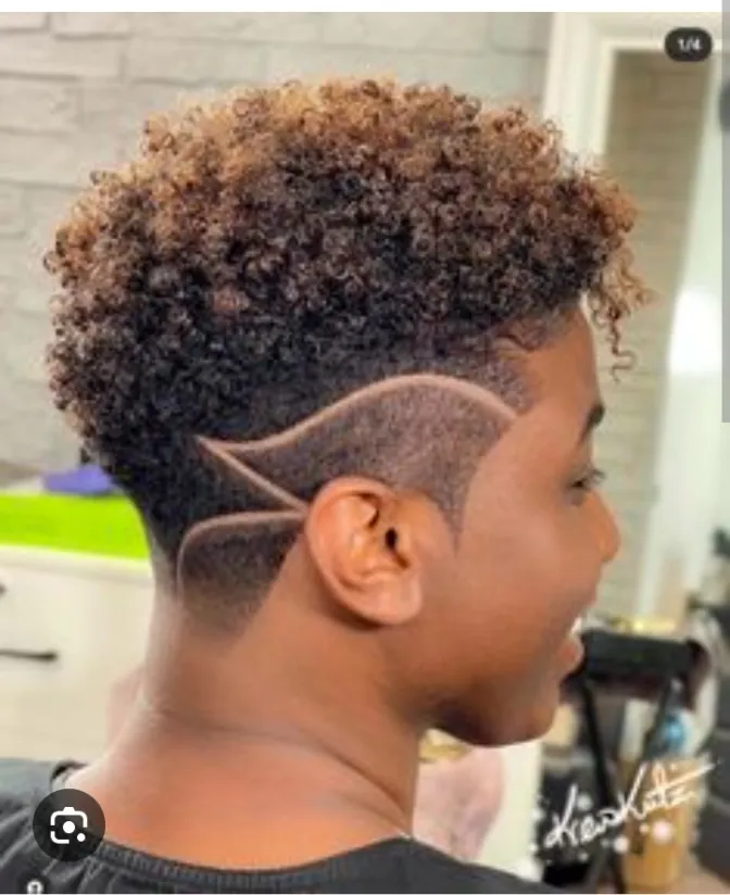 Intricate shaved razor line design in a faded side